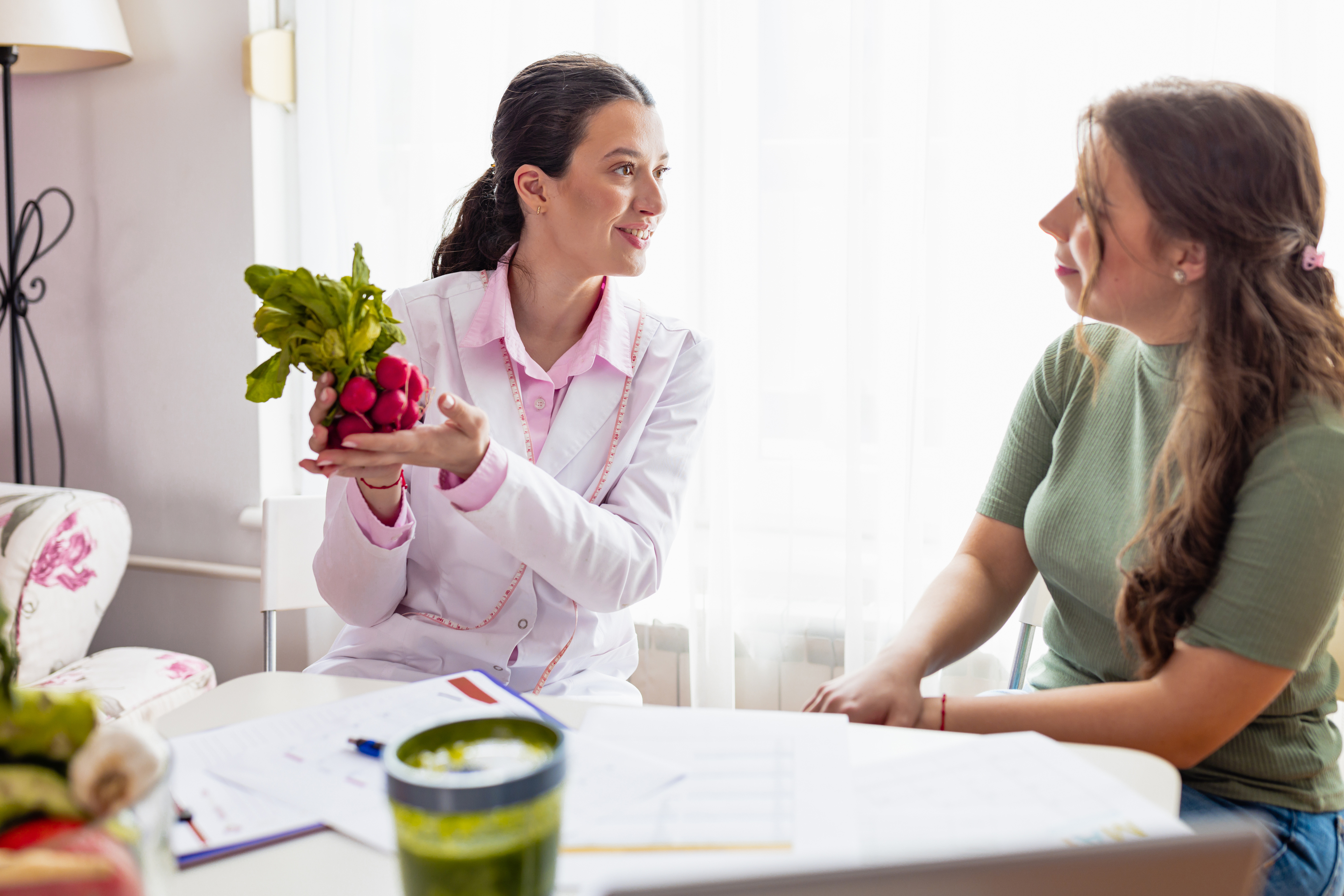 Young female nutritionist in her clinic provides professional nutritional guidance for all ages