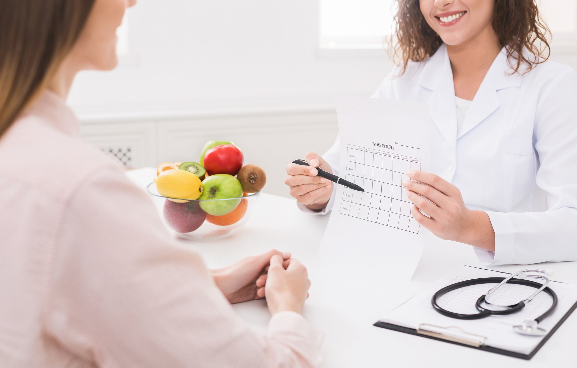 Healthy nutrition expert making weekly meal plan for client